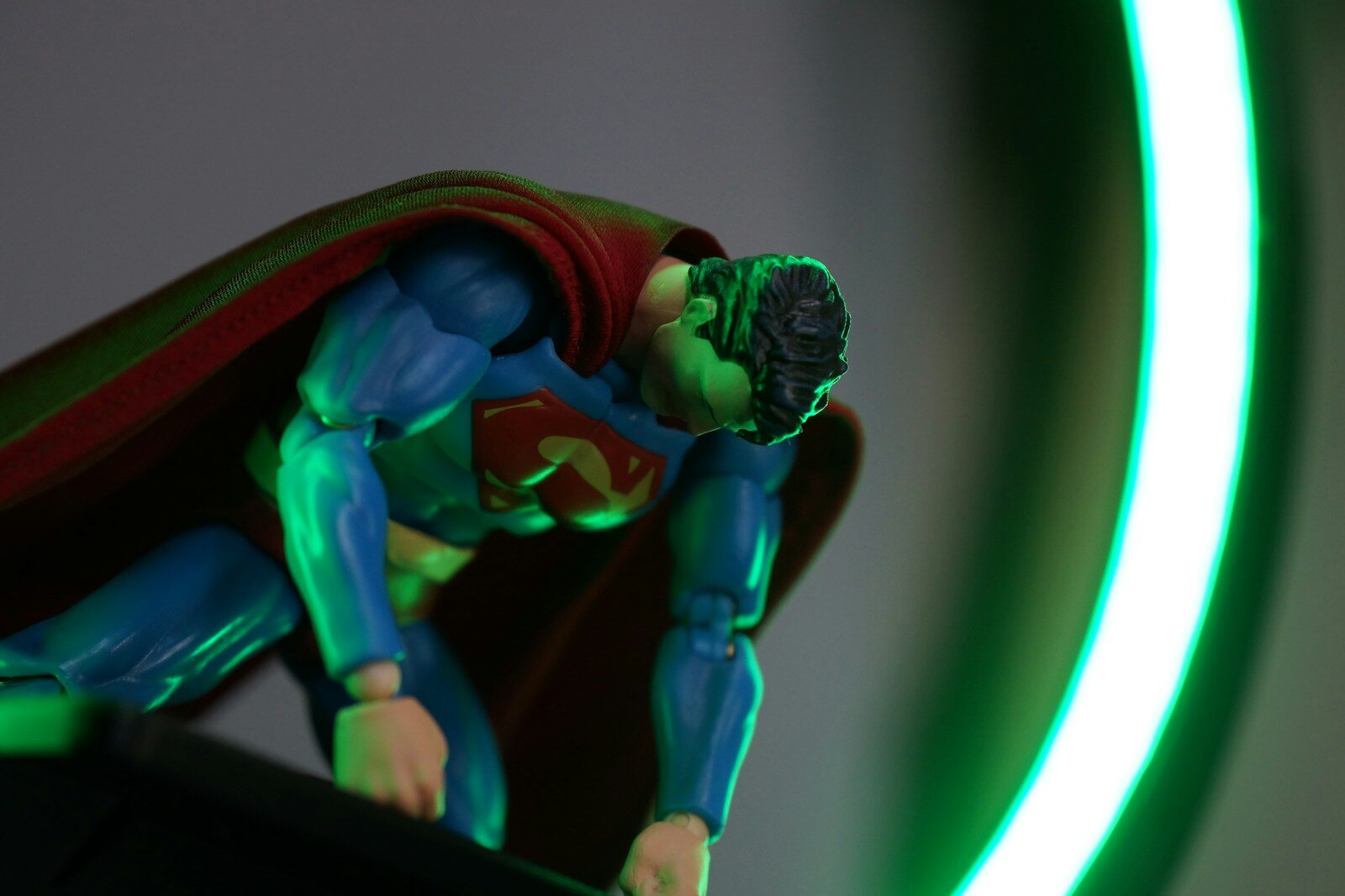Superman action figure with a glowing green light.